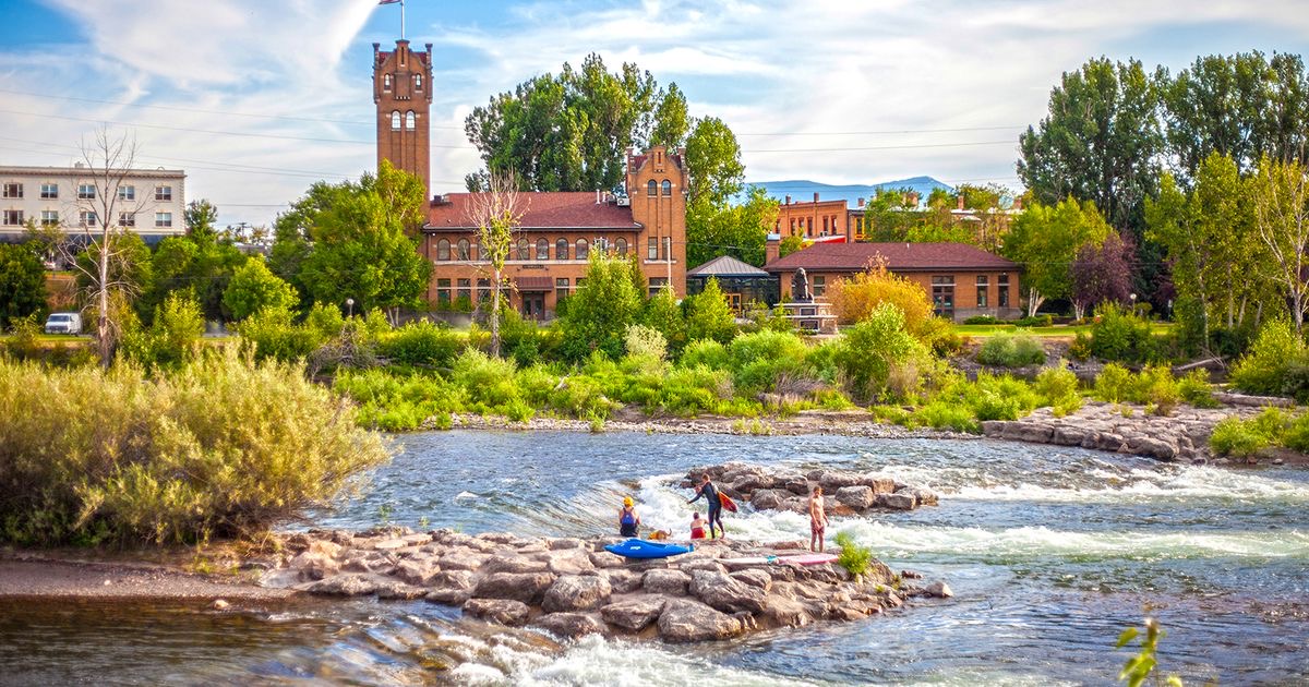 Surfers on the Clark Fork River wave in downtown Missoula, Montana