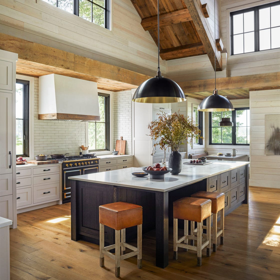 Montana farmhouse kitchen with reclaimed beams and a dark island